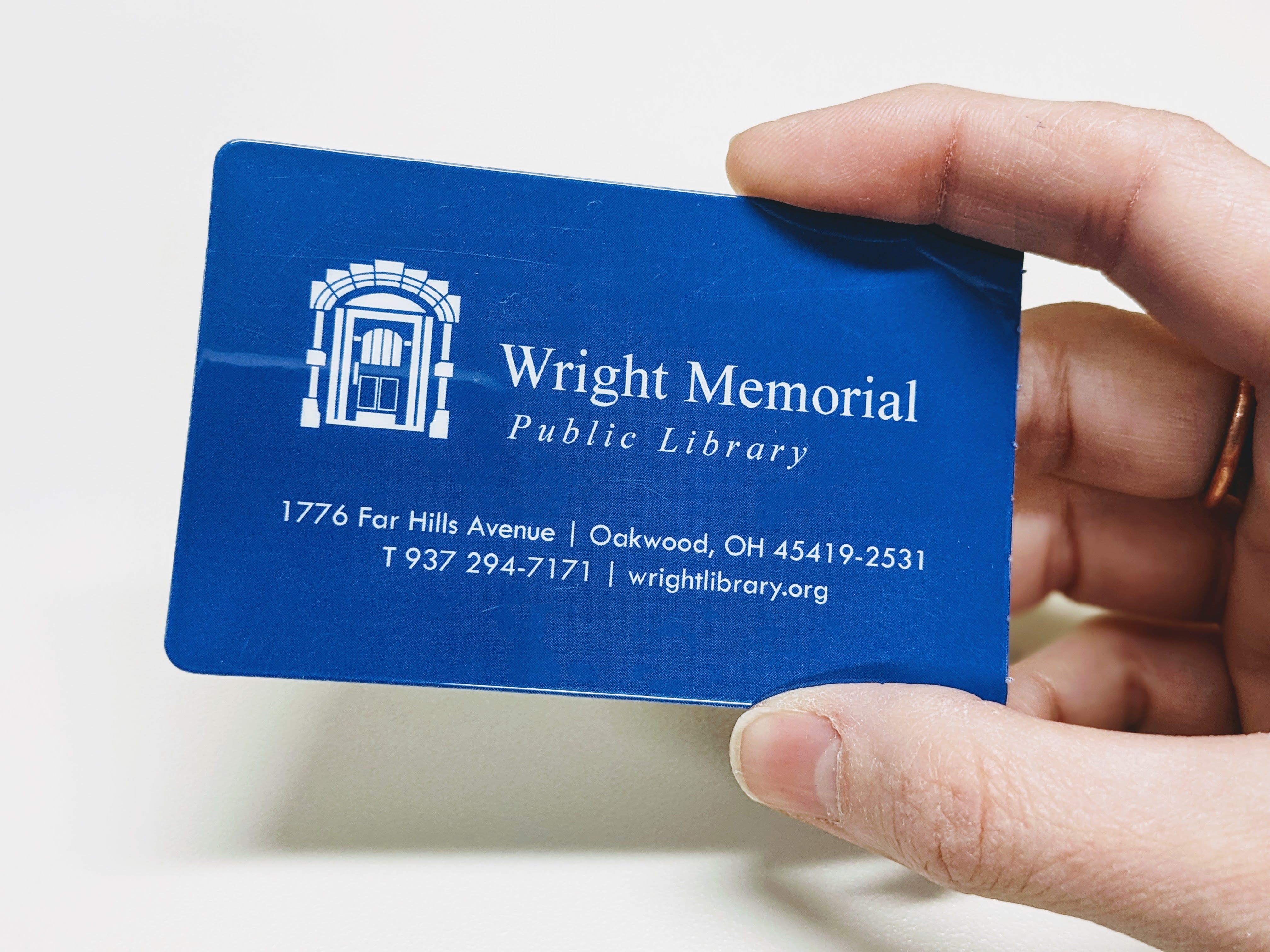 hand holding a Wright Library card