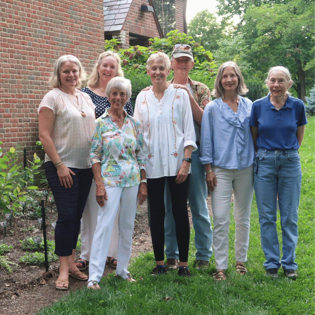 Volunteers stand by Wright Library shade garden