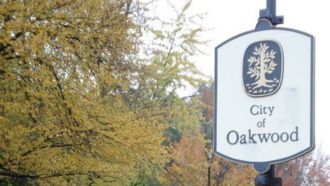 Welcome to Oakwood sign amongst autumn trees