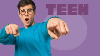 Teen boy in teal shirt points with mouth agape.