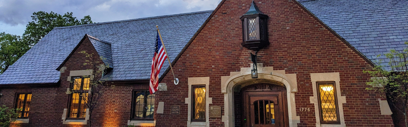 Front of the Wright Library building. A classic brick building with narrow windows on either side of the front door and a black shingle roof