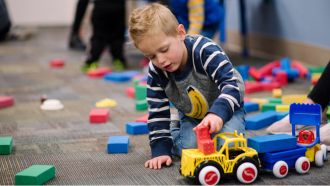 Child plays with toy train