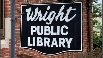 metal "Wright Public Library" sign outside library