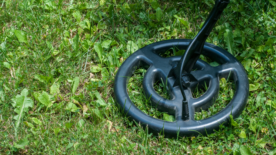 A metal detector on the grass