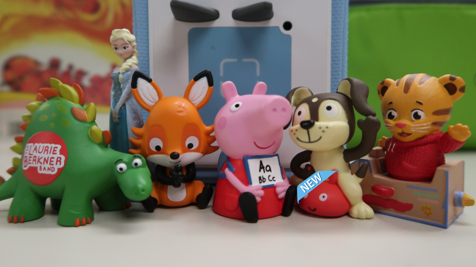 Toniebox with characters dinosaur, fox, Pepa Pig, dog, and Daniel Tiger.