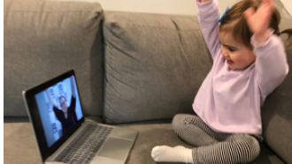 toddler hands up watching librarian with hands up on laptop