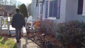 librarian walking library books to patron's front door 