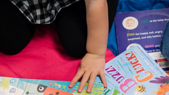 toddler hand selecing board books