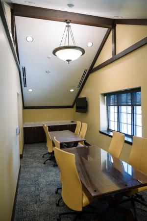 2 tables, 8 chairs, and wall-mounted TV screen in the Shank Conference Room