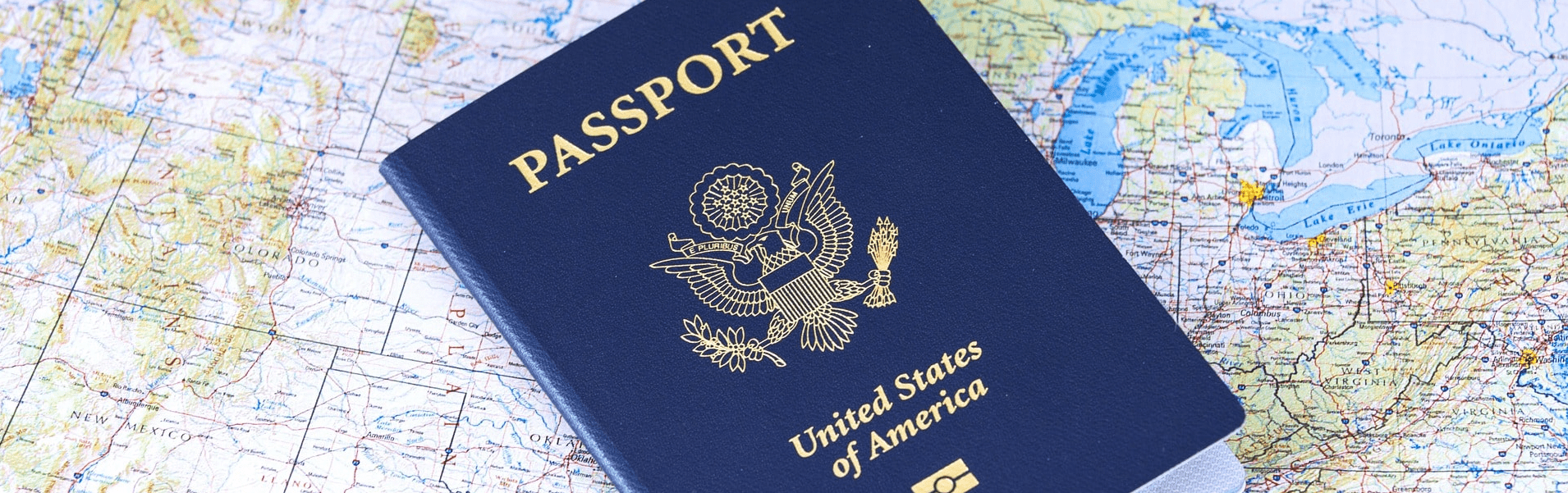 A US passport lies on a map of the United States